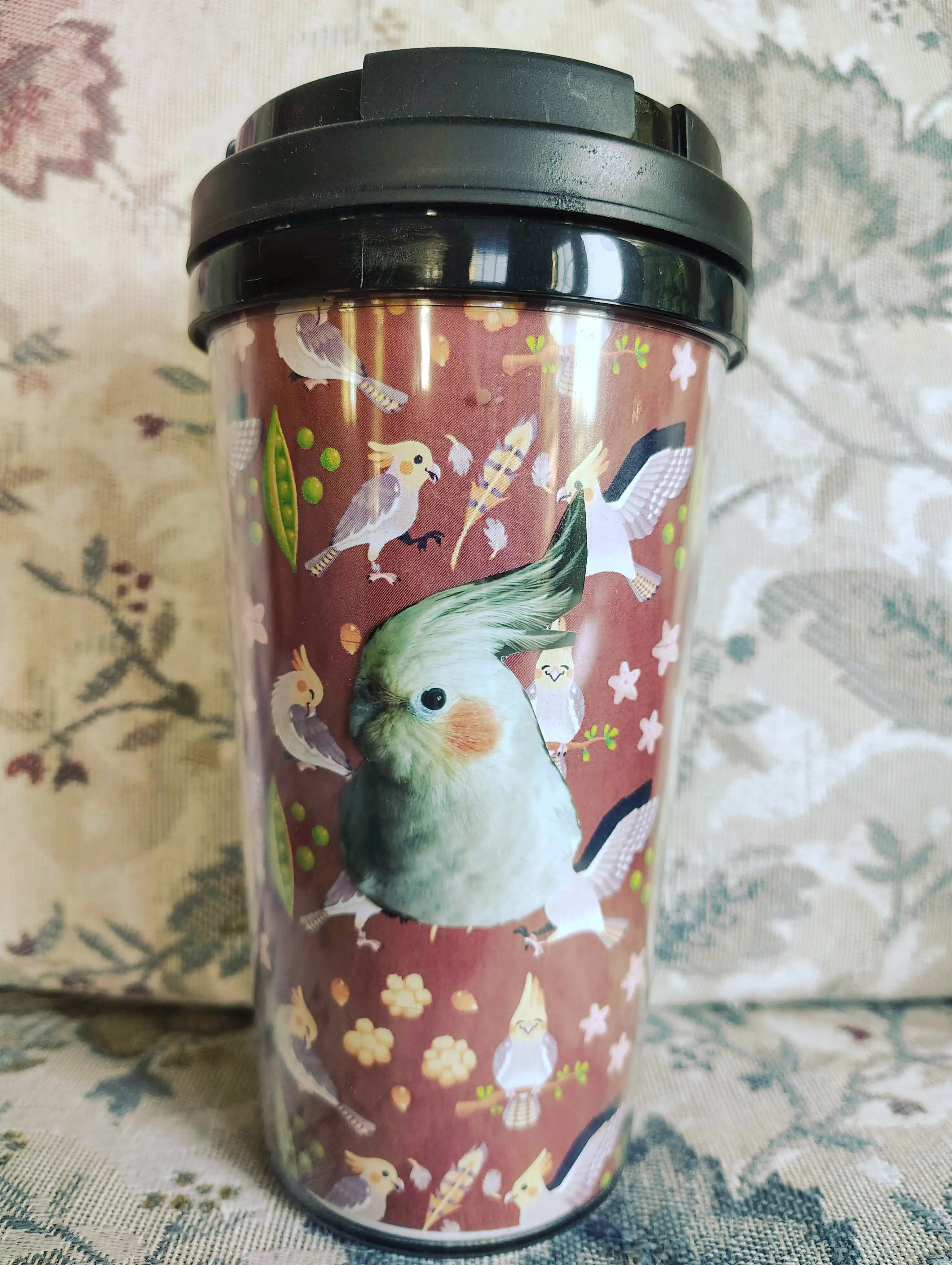 A photo of the Perry the Cockatiel pattern inserted into a coffee cup. There are real pictures of Perry collaged with it.
